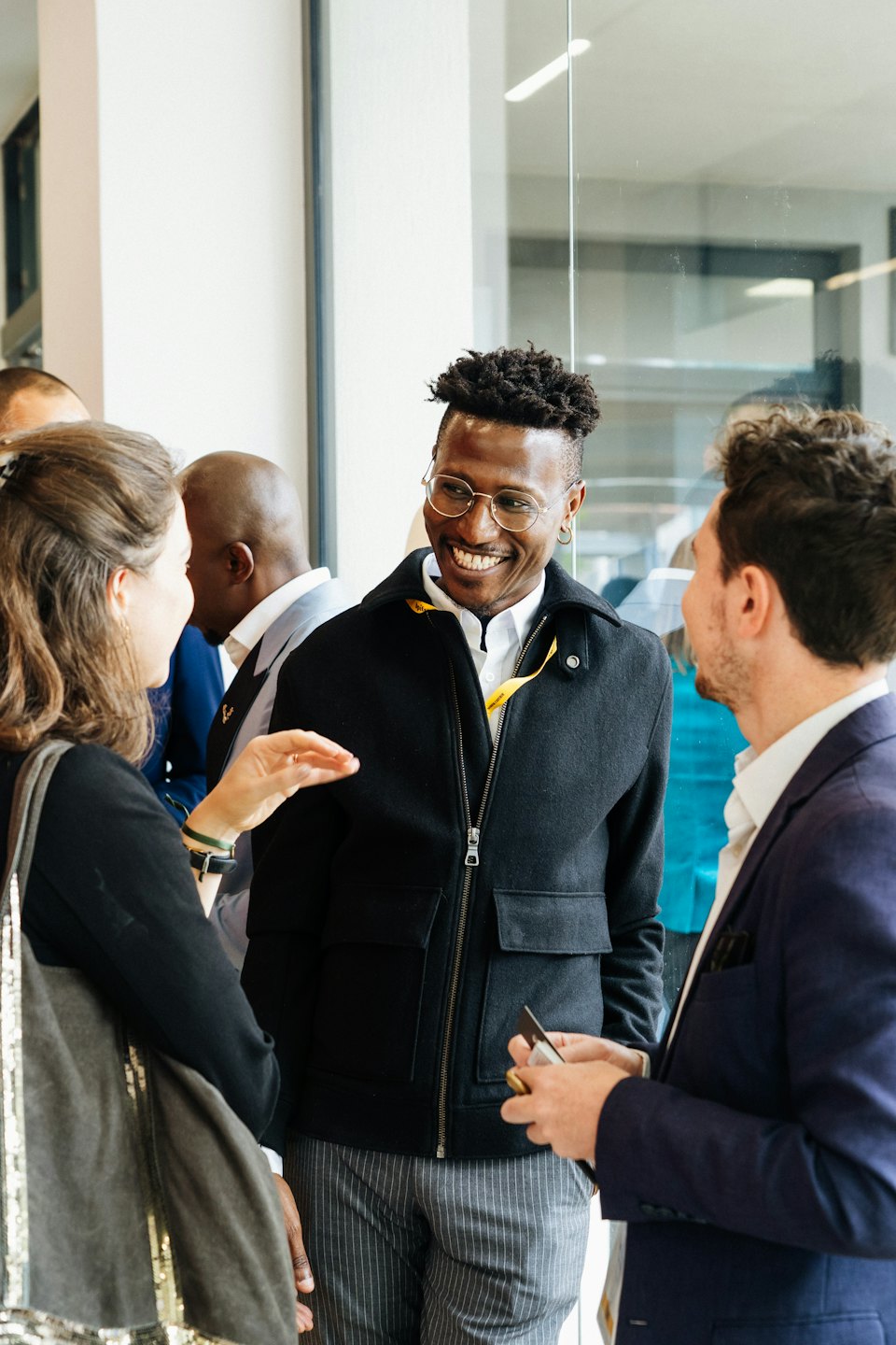 Professionals networking and conversing in a modern office.